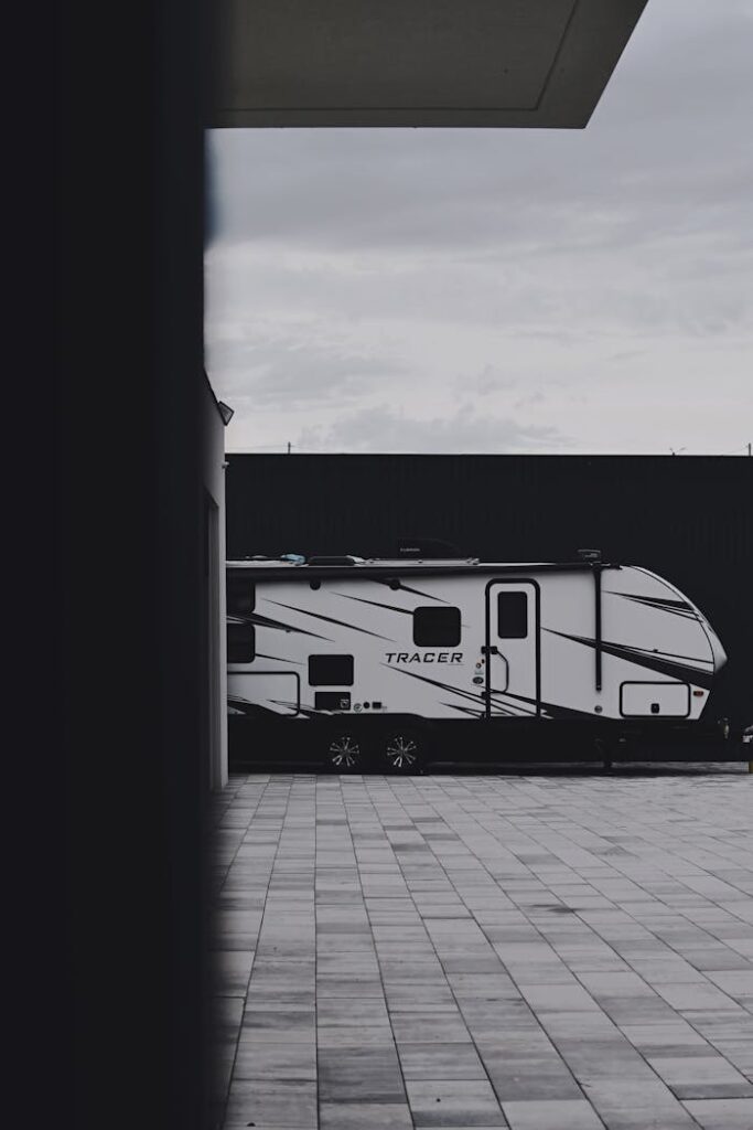The Art of Drawing Readers In: Your attractive post title goes here Sleek Tracer caravan parked outdoors on a tiled surface, emphasizing modern travel lifestyle.