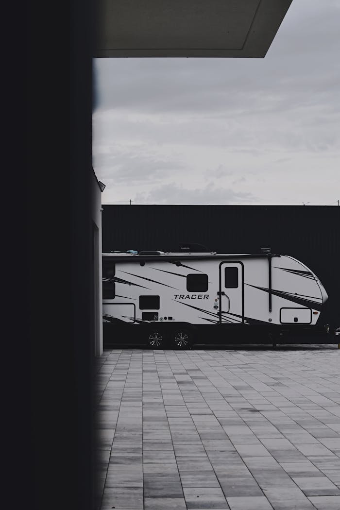 Sleek Tracer caravan parked outdoors on a tiled surface, emphasizing modern travel lifestyle.